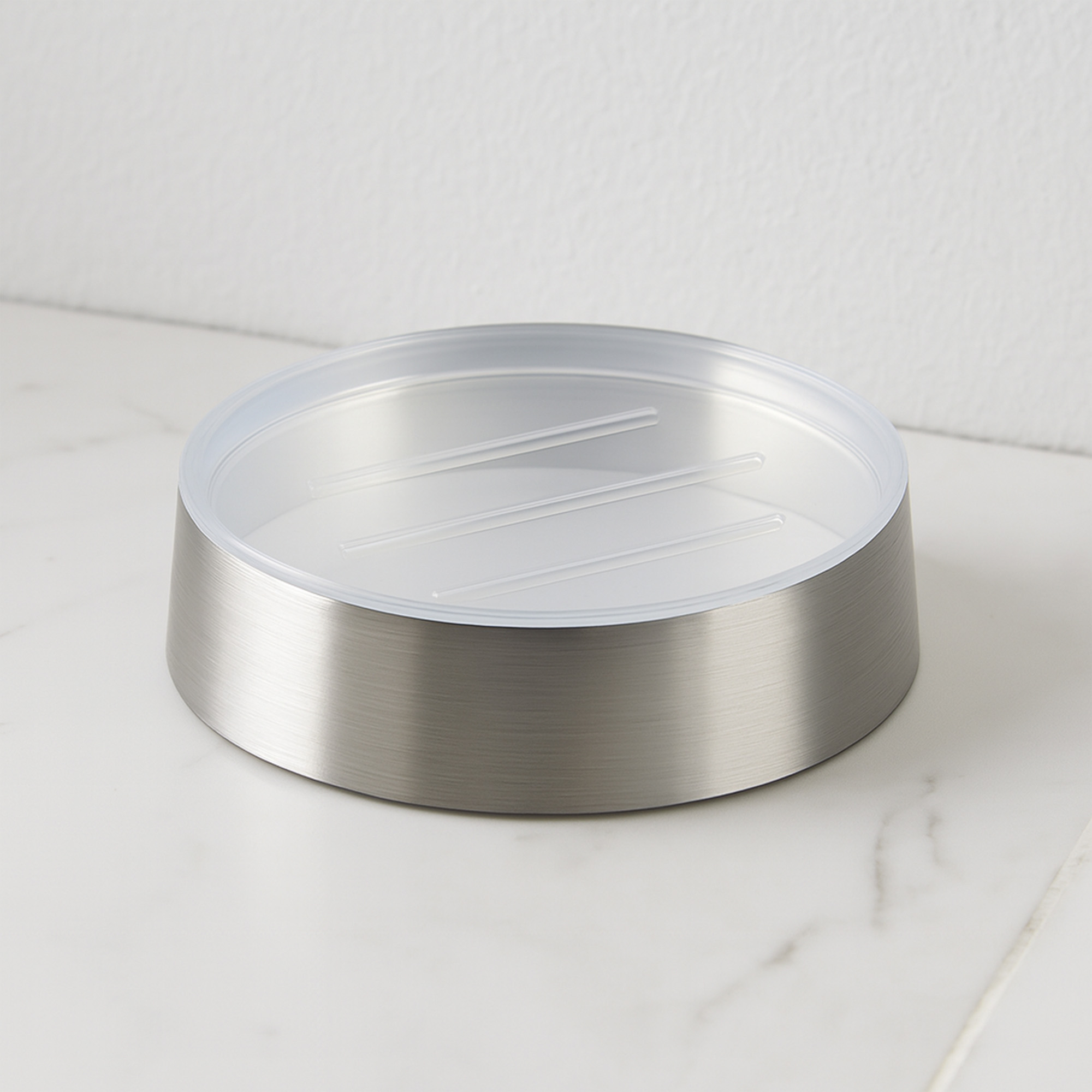 Empty brushed aluminum soap dish with clear bottom detail