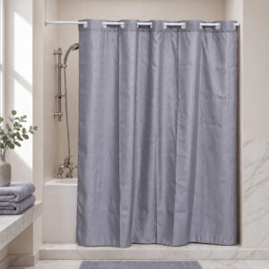 Gray extra long hookless shower curtain hanging on a rod in a bright bathroom with a bathtub