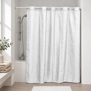 White extra long hookless shower curtain hanging on a rod in a bright bathroom with a bathtub