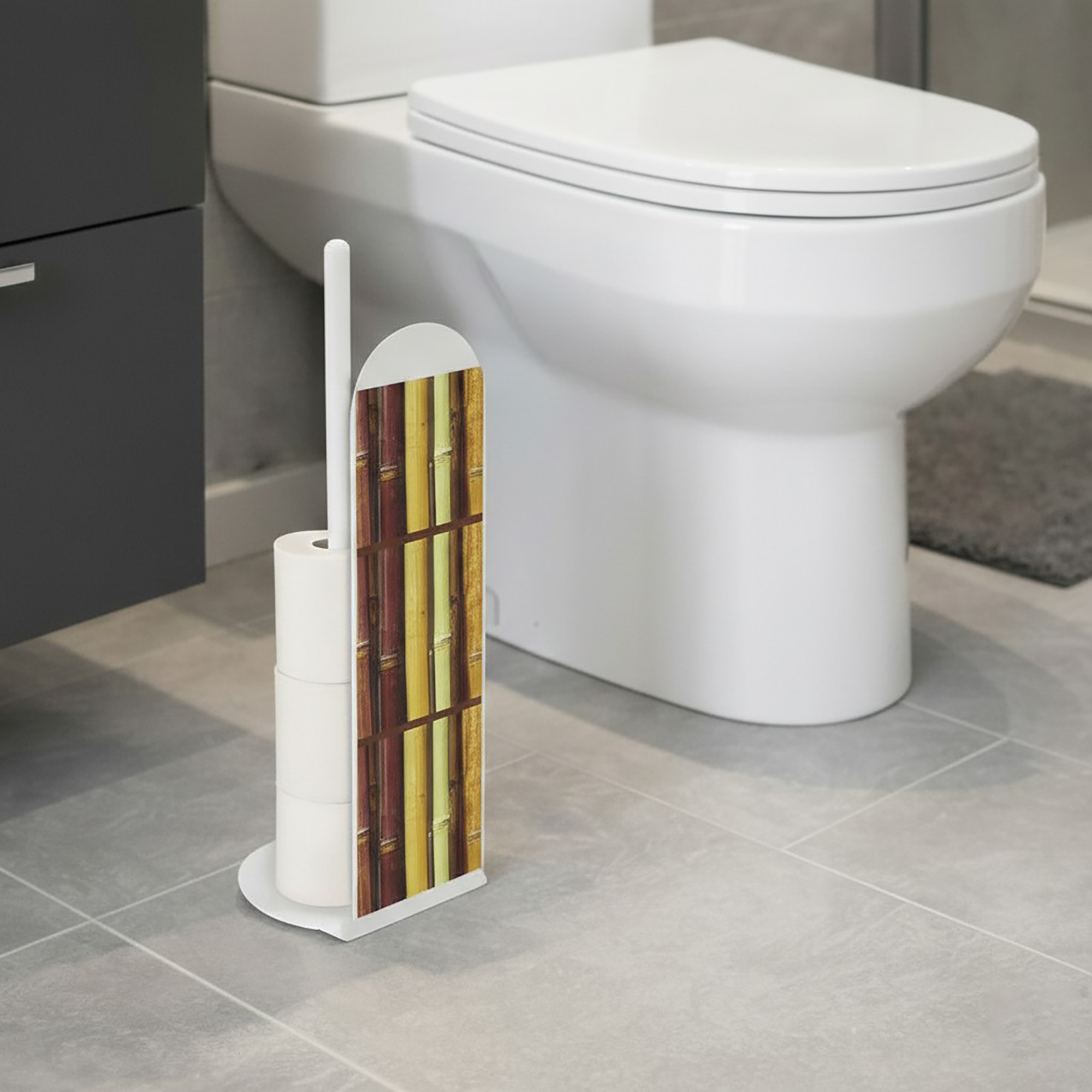 White freestanding toilet paper holder with colorful bamboo stalk design panel, storing extra rolls