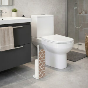 White freestanding toilet paper holder with brown and white Moroccan quatrefoil geometric pattern panel