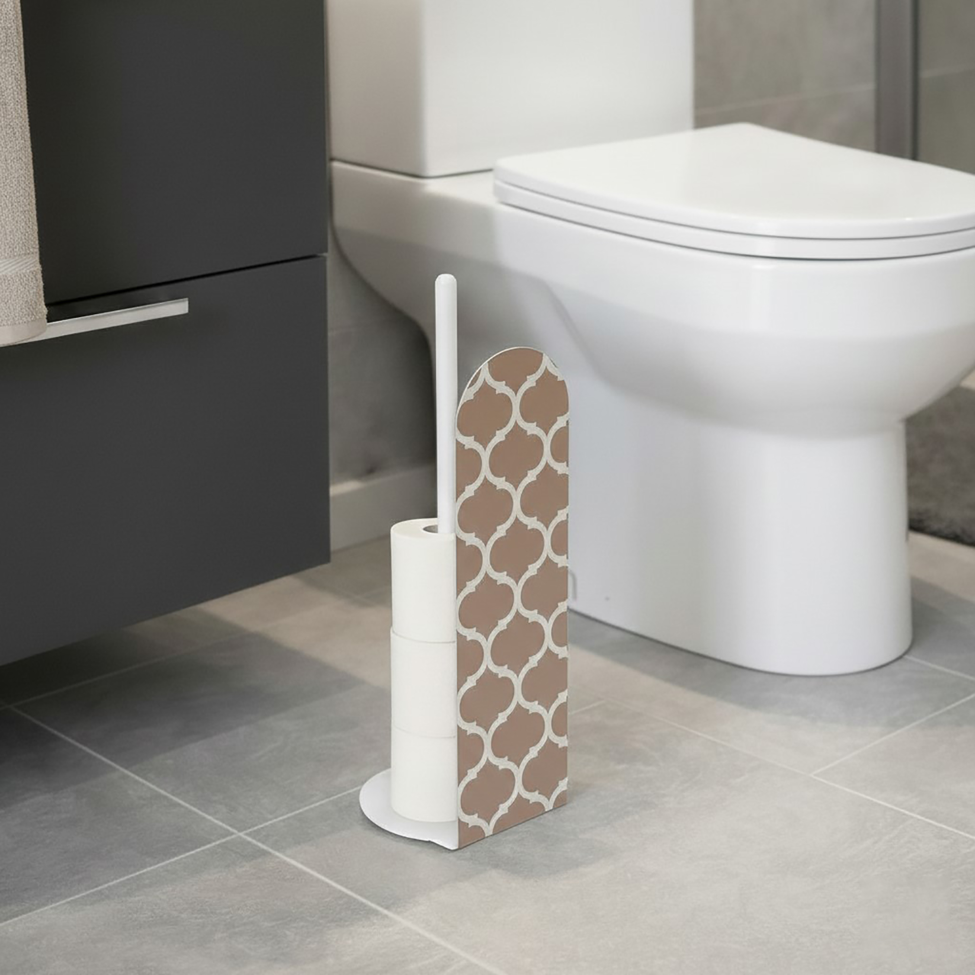 White freestanding toilet paper holder with brown and white Moroccan quatrefoil geometric pattern panel