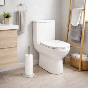 Freestanding toilet paper holder with brushed stainless steel rod and base, holding stacked white rolls