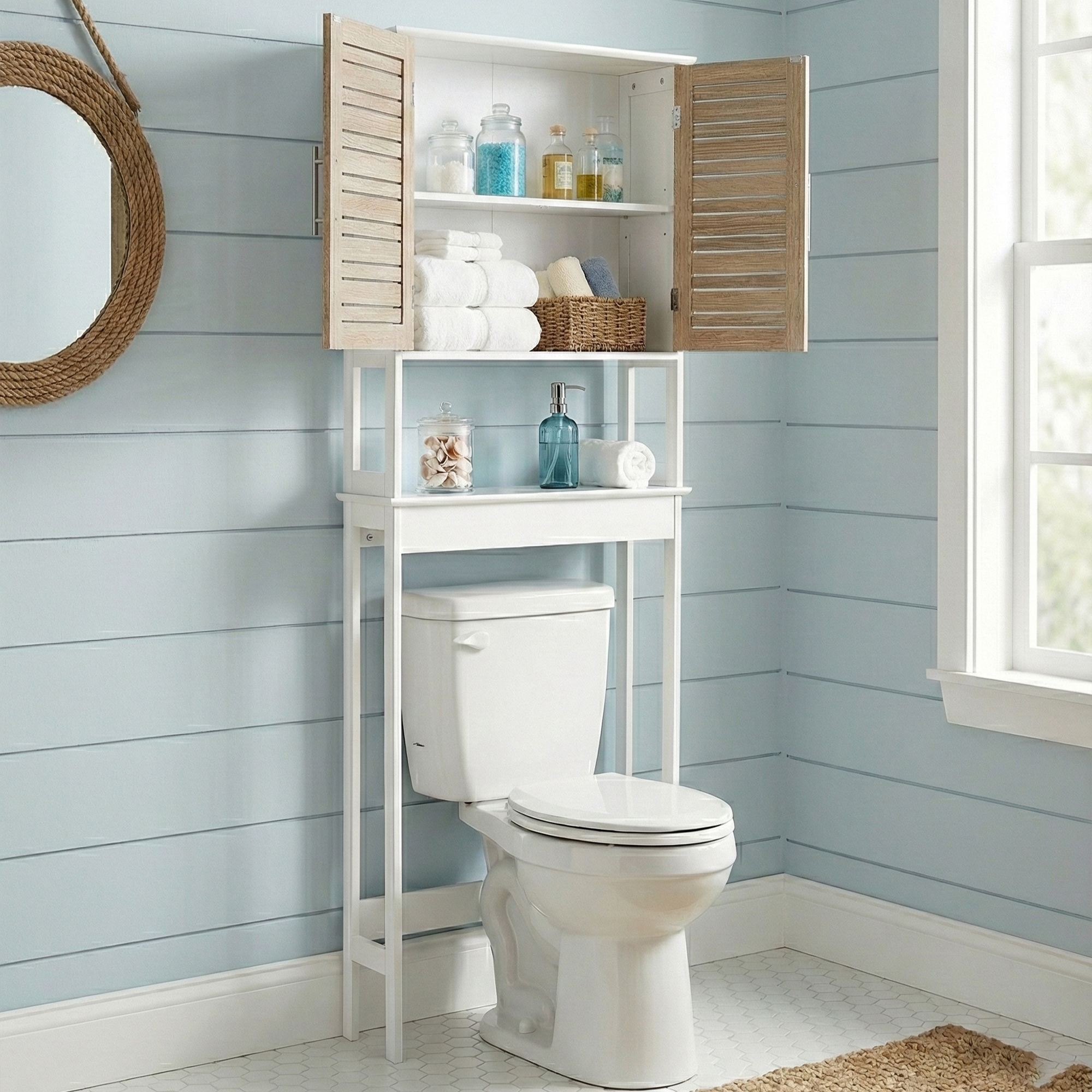 Front view of an over-the-toilet storage cabinet in white with wood-look vented doors and stainless steel handles.
