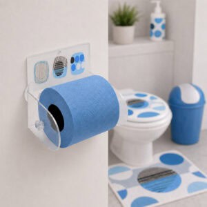 Street Art clear acrylic toilet paper holder mounted on wall holding a blue roll, with toilet, matching blue-and-grey seat cover, blue swing-lid bin, and coordinating bath mat in the background.