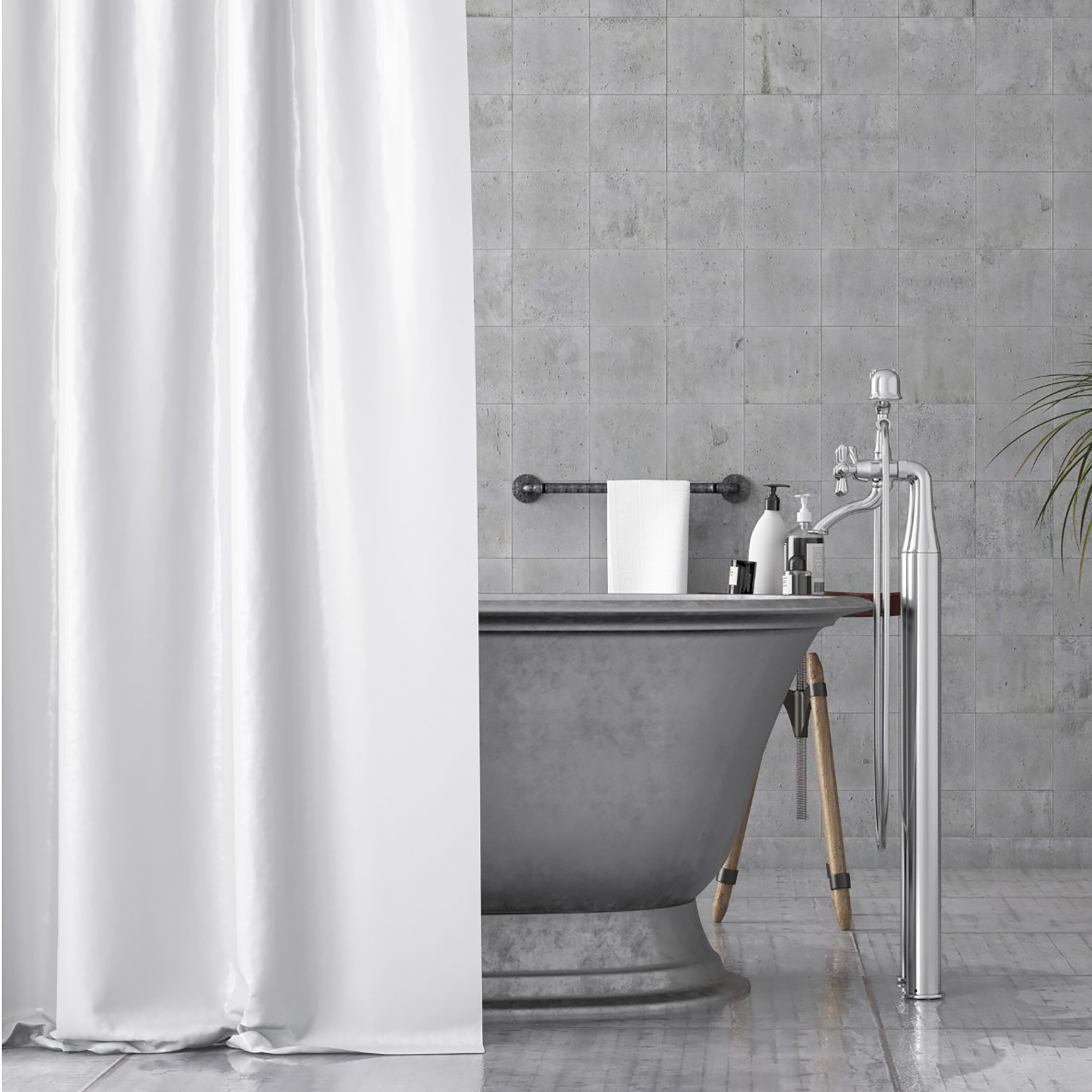 White shower curtain partially covering freestanding bathtub in grey bathroom