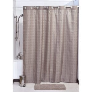 Taupe hookless shower curtain with cubic pattern hanging in bathtub setup