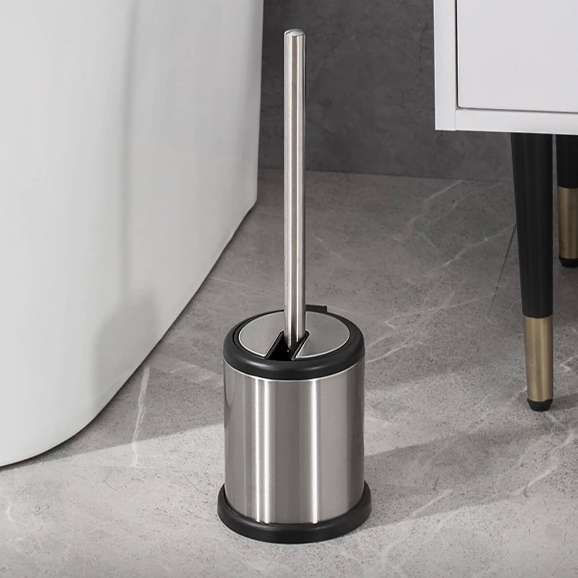 Stainless steel toilet brush holder placed in a stylish bathroom setting, showcasing its contemporary design.