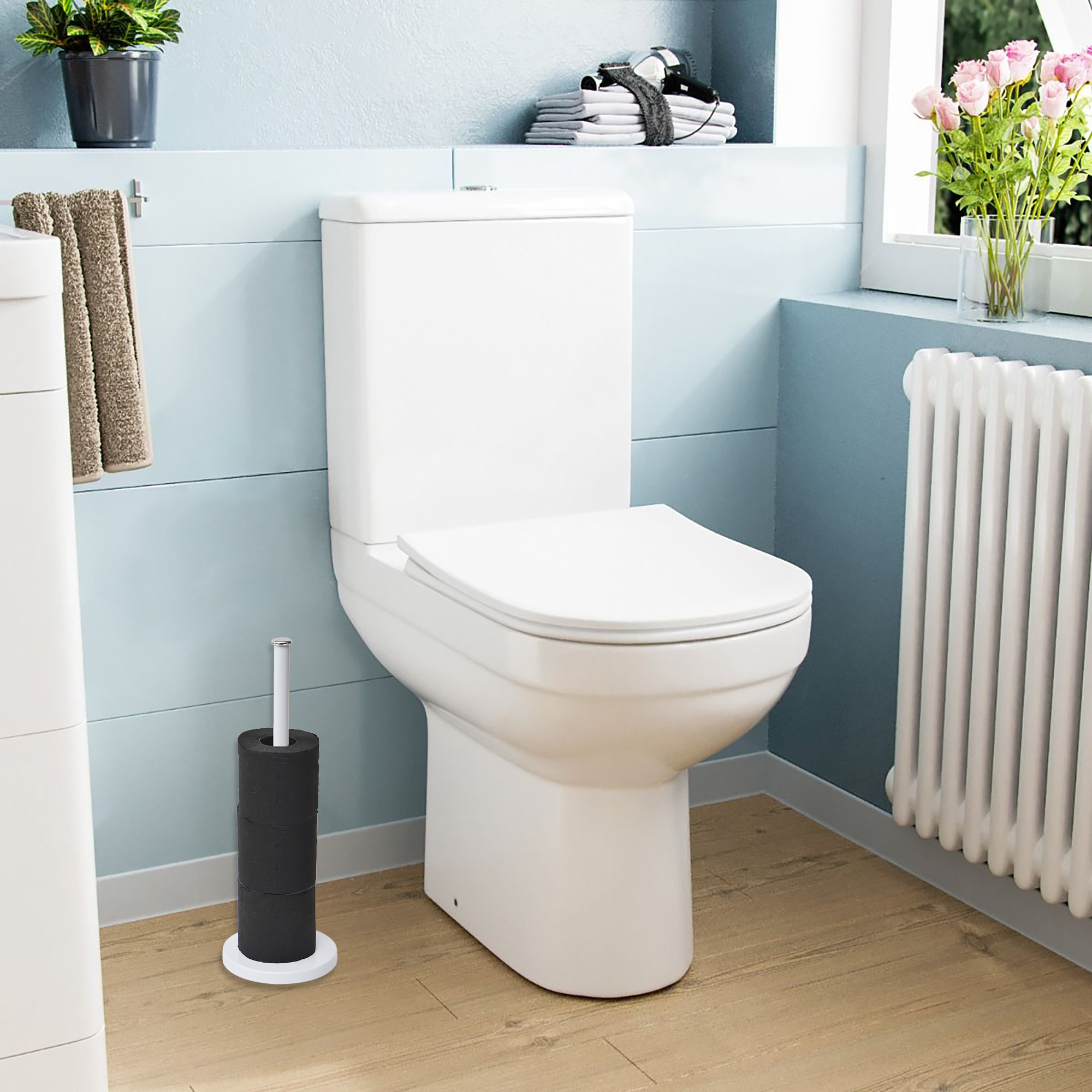 White toilet paper holder beside a modern toilet in a clean, bright bathroom setting