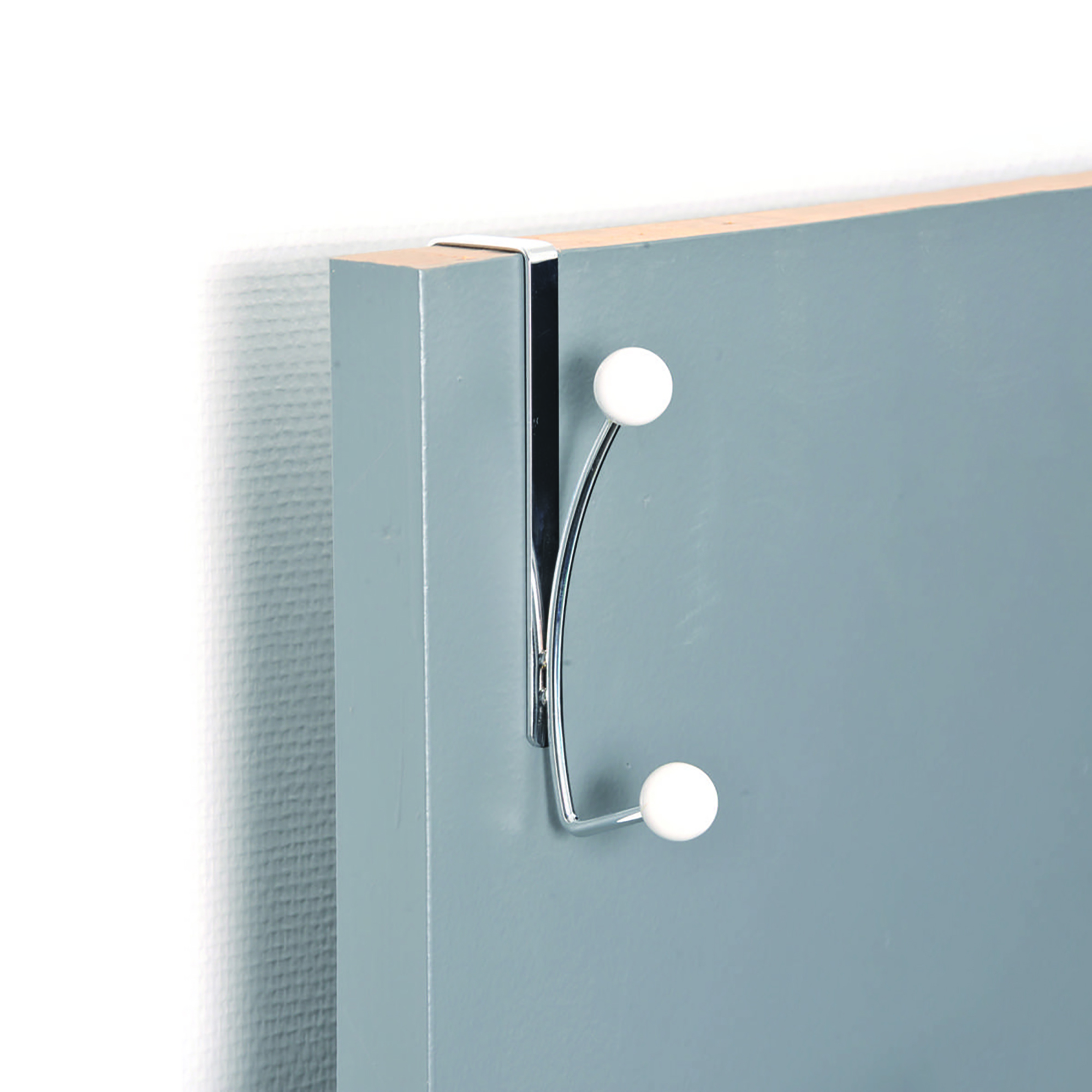 Over-the-door chrome hook mounted on a blue interior door