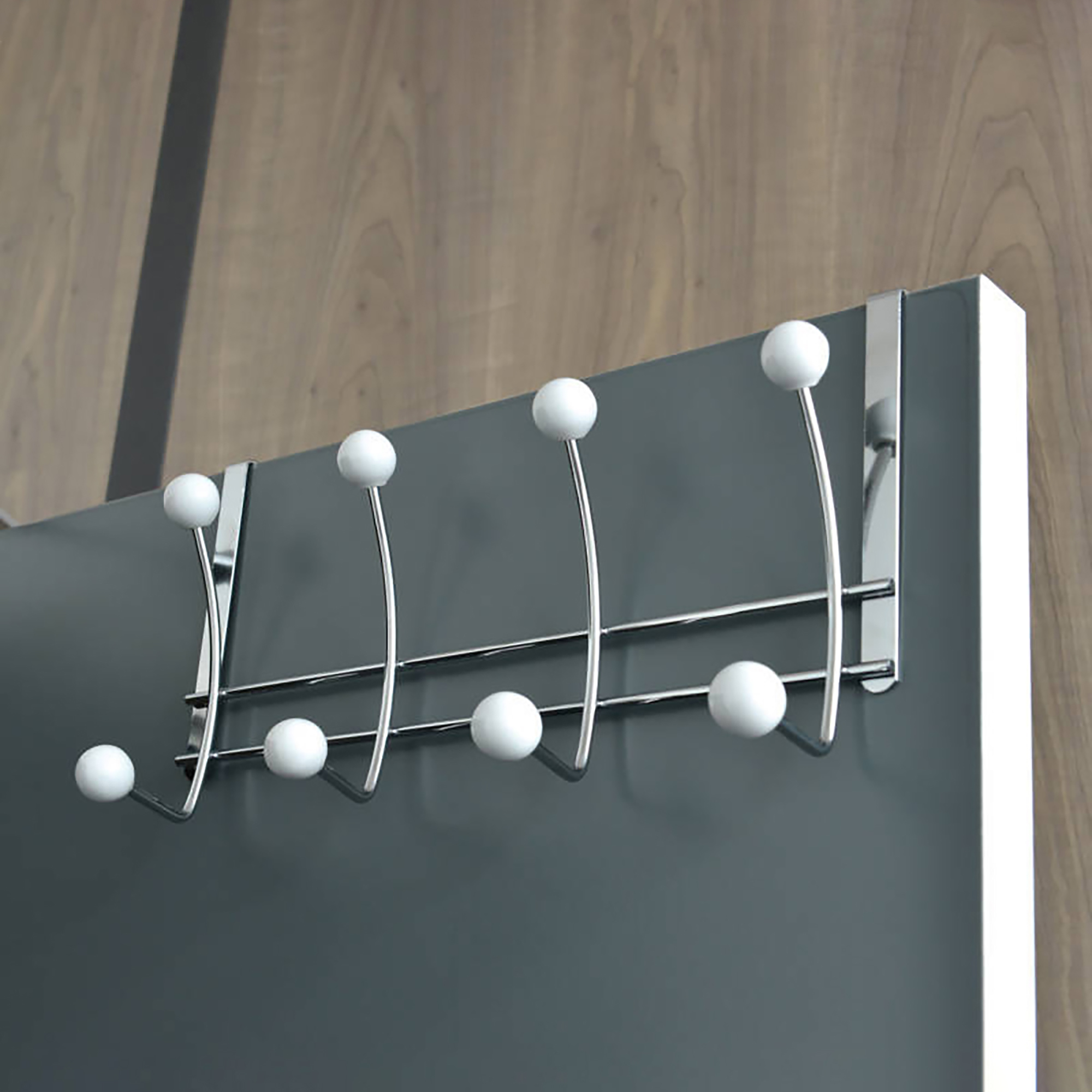 Chrome hook rack hanging over a gray door with white ball ends