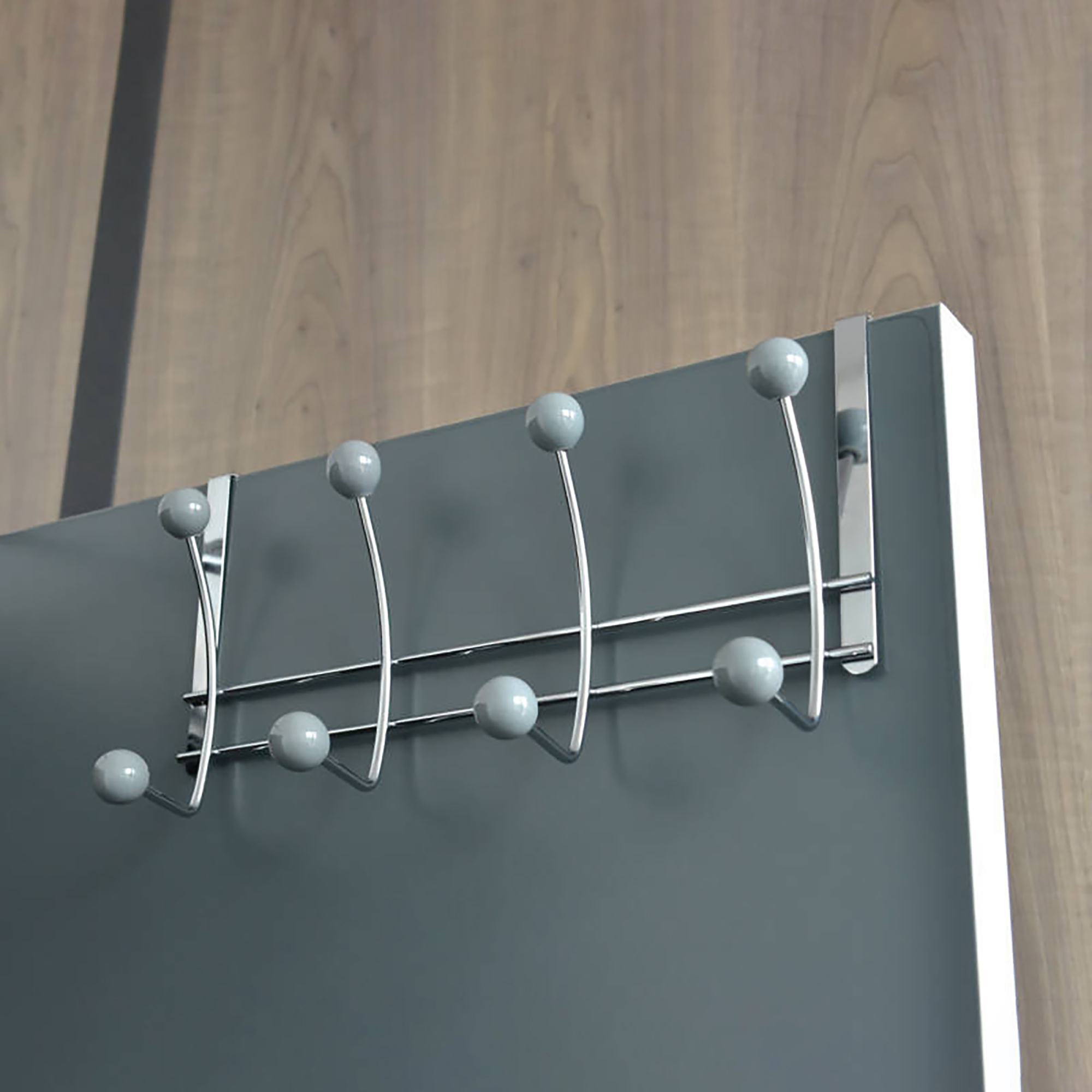 Chrome hook rack hanging over a gray door with gray ball ends