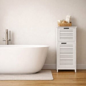 White slatted two-door bathroom floor cabinet with wicker basket of bath accessories on top, beside a freestanding bathtub on wood floor