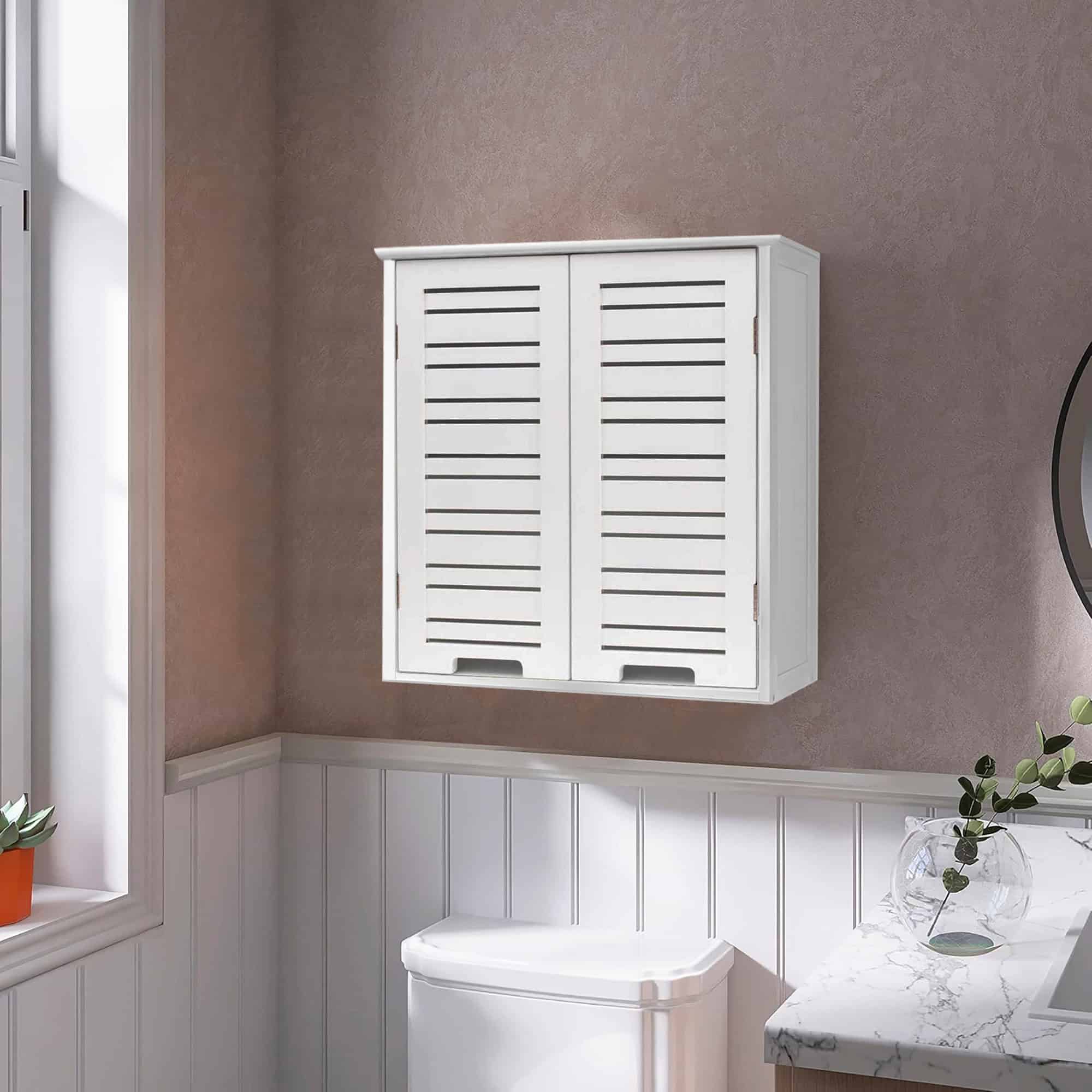 In-use view of wall-mounted cabinet above toilet – White wall-mounted cabinet positioned above a toilet in a modern bathroom with beige walls and white paneling, styled for a neat and functional look.