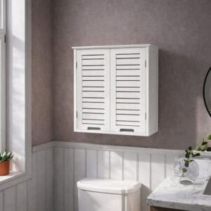 "White double-door louvered wall cabinet mounted above a toilet in a grey panelled bathroom"