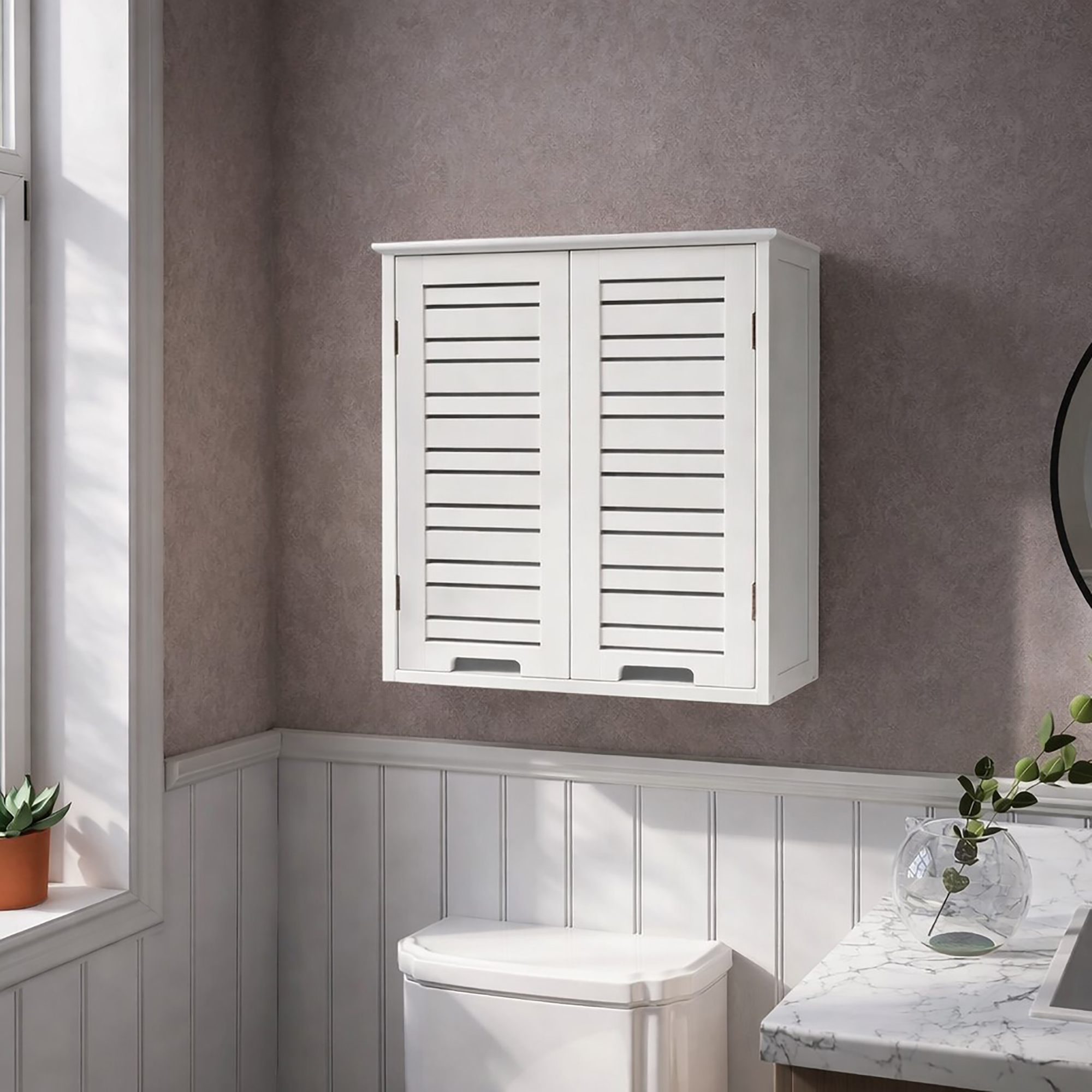 "White double-door louvered wall cabinet mounted above a toilet in a grey panelled bathroom"