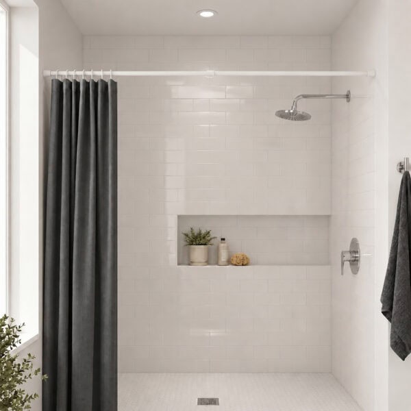 White tension shower curtain rod installed in modern bathroom with grey curtain, walk-in shower with subway tile and niche