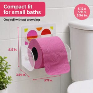 Eclats clear acrylic toilet paper holder on tile holding a pink roll. "Compact fit for small baths" / "One roll without crowding". Dimensions 5.12 x 5.71 x 3.94 in.