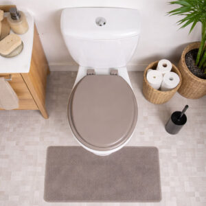 Taupe round toilet seat installed on toilet top view