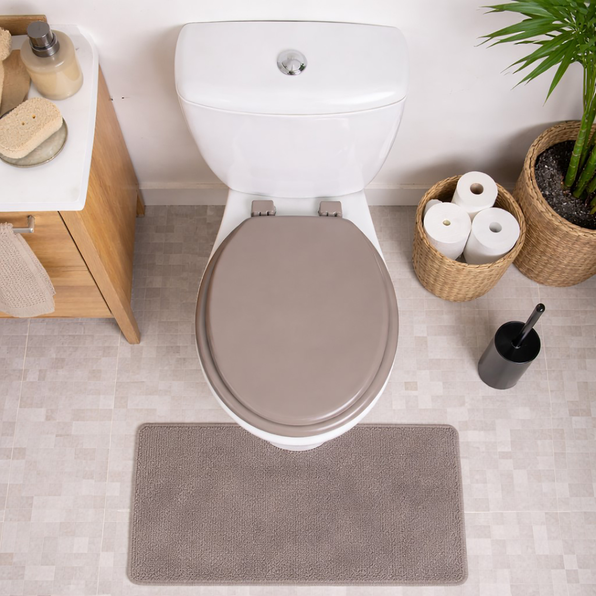 Taupe round toilet seat installed on toilet top view