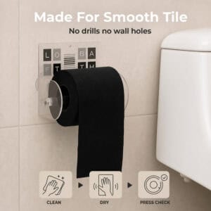 Loft Bath clear acrylic toilet paper holder on beige tile holding a black roll. "Made For Smooth Tile" / "No drills no wall holes", with clean, dry, and press-check icons.