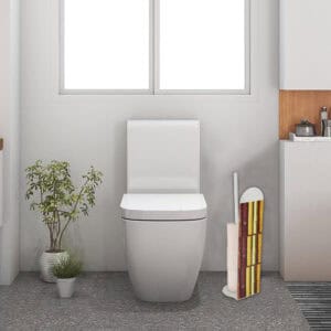 Freestanding bamboo-pattern toilet paper holder positioned beside white toilet in minimalist bathroom