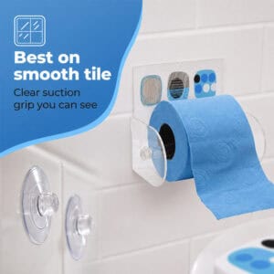 Street Art clear acrylic toilet paper holder on tile holding a blue roll, spare suction cups shown. "Best on smooth tile" / "Clear suction grip you can see".