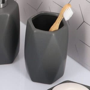 Matte gray bathroom tumbler close-up with toothbrush