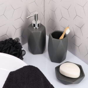 Matte gray bathroom accessories arranged on countertop
