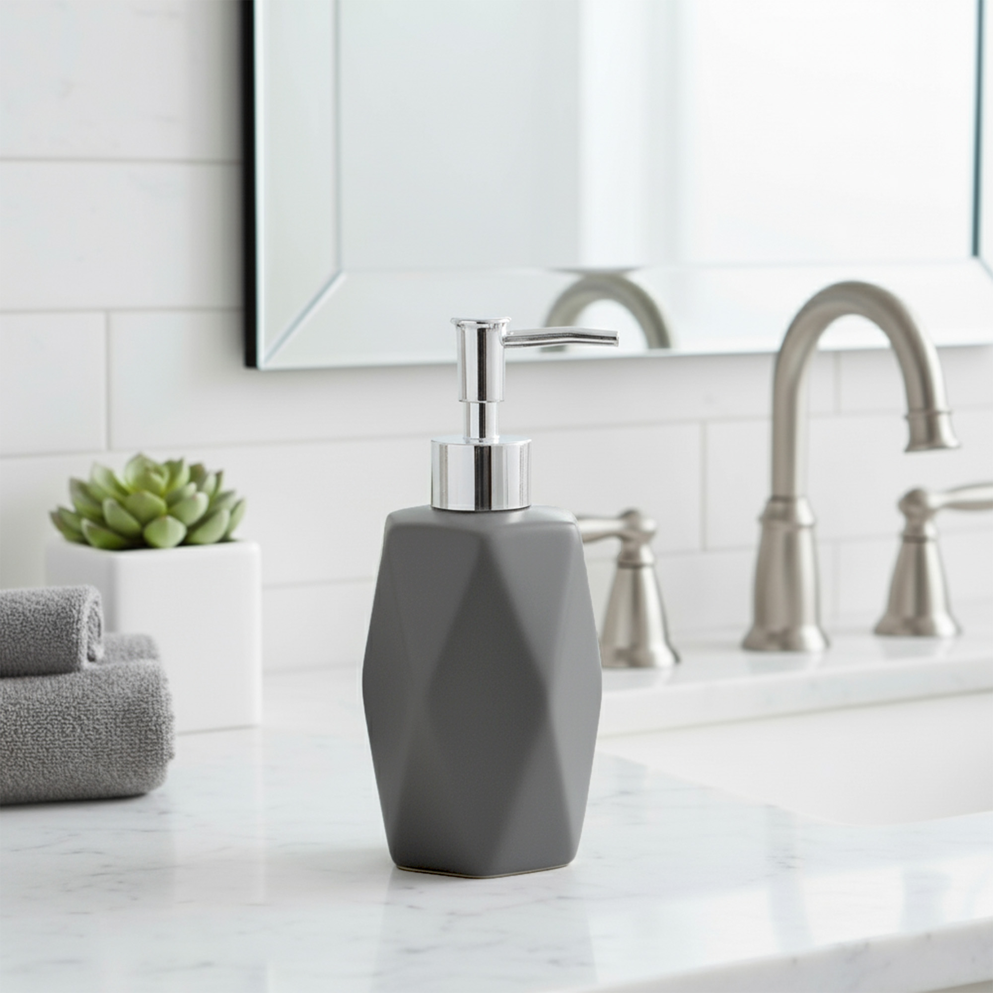 Matte gray soap dispenser on marble bathroom counter