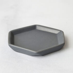 Empty matte grey geometric soap dish on light surface