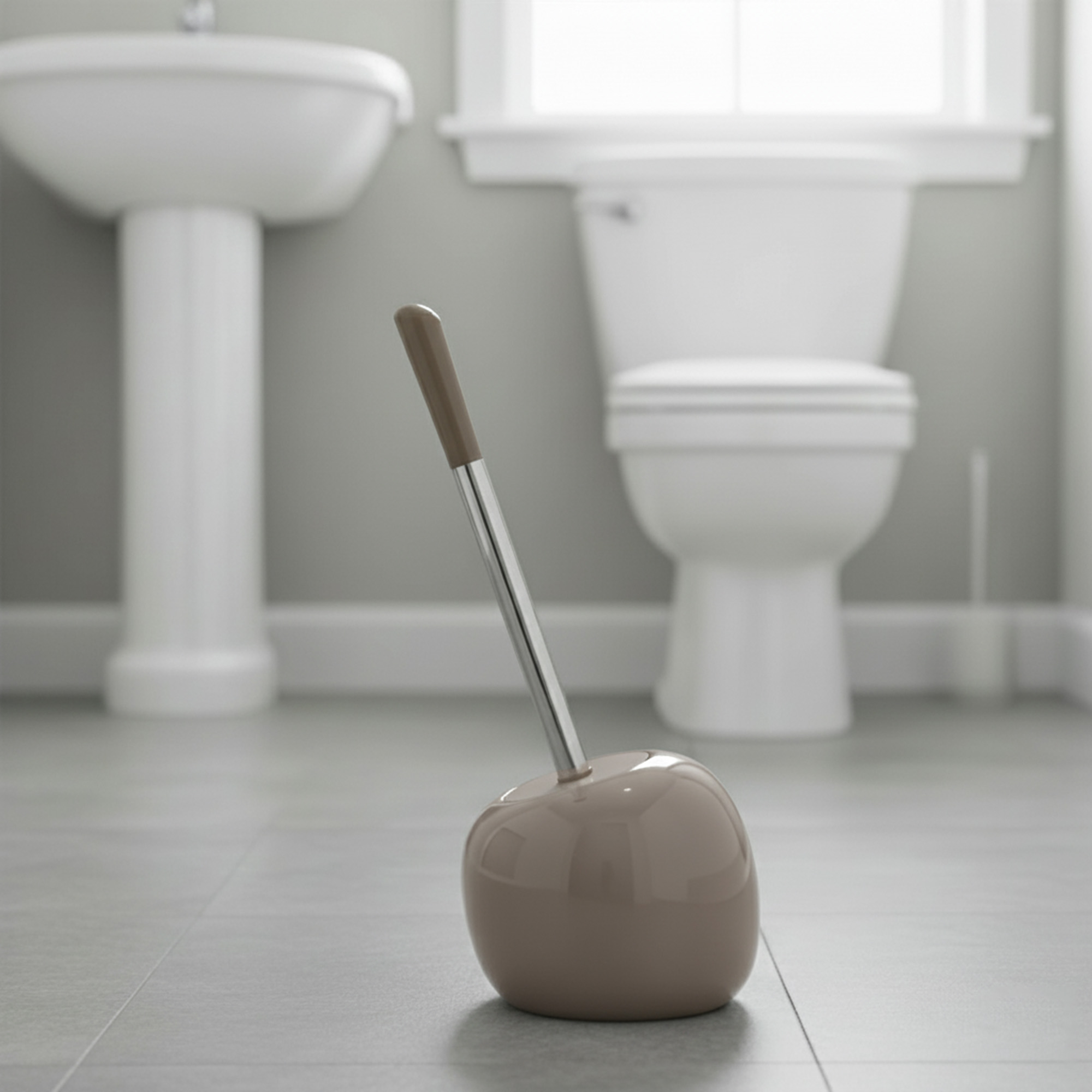 Taupe round toilet brush holder with stainless steel handle and taupe top in modern bathroom