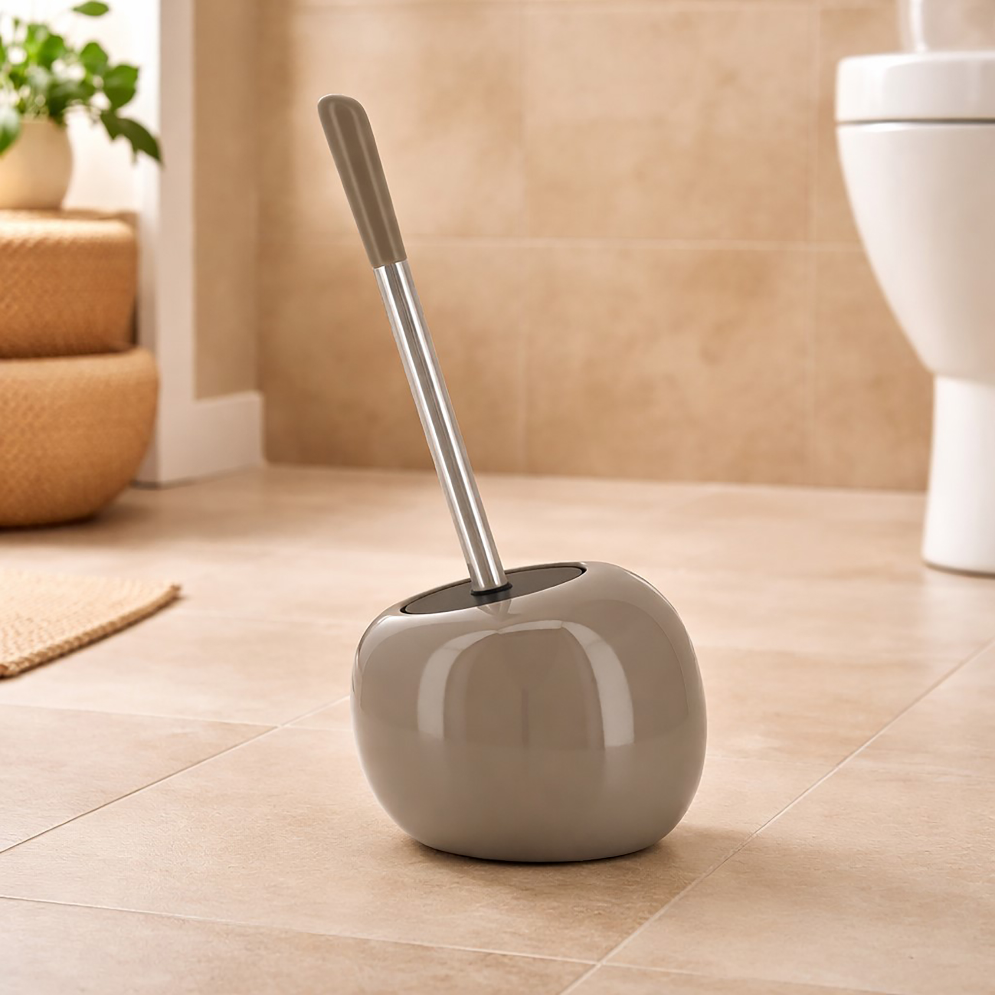 Taupe round dolomite toilet brush holder with stainless steel handle in warm bathroom setting