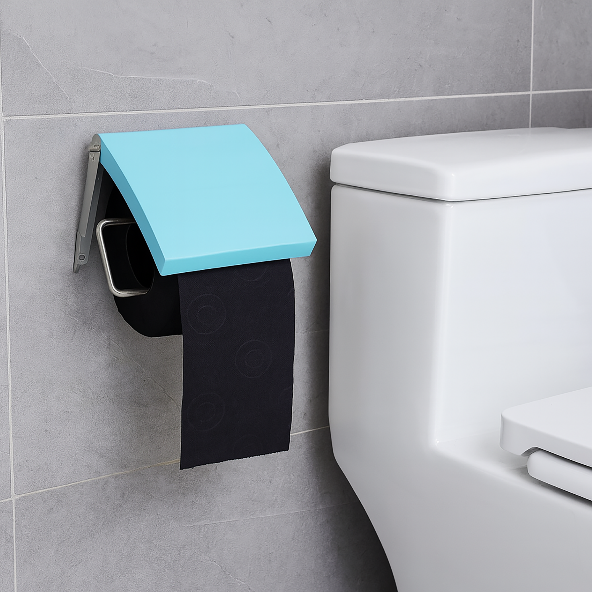 Wall-mounted aqua blue toilet paper dispenser with covered design on gray bathroom wall next to toilet