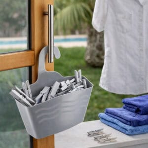 Grey hanging shower caddy filled with clothespins hanging on outdoor door handle