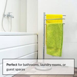 "Chrome 3-arm swivel towel rack holding yellow and green towels beside bathtub"