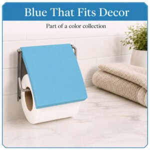 Aqua Blue cover toilet paper holder mounted on white subway tile holding a white roll under a flip-up blue cover, styled with towels and a plant. "Blue That Fits Decor" / "Part of a color collection".