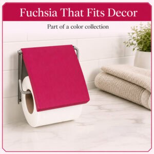 Fuchsia cover toilet paper holder mounted on white subway tile holding a white roll under a flip-up fuchsia cover, styled with towels and a plant. "Fuchsia That Fits Decor" / "Part of a color collection".