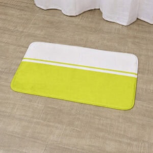 Close-up of green and white striped rectangular bath mat on wood-look floor