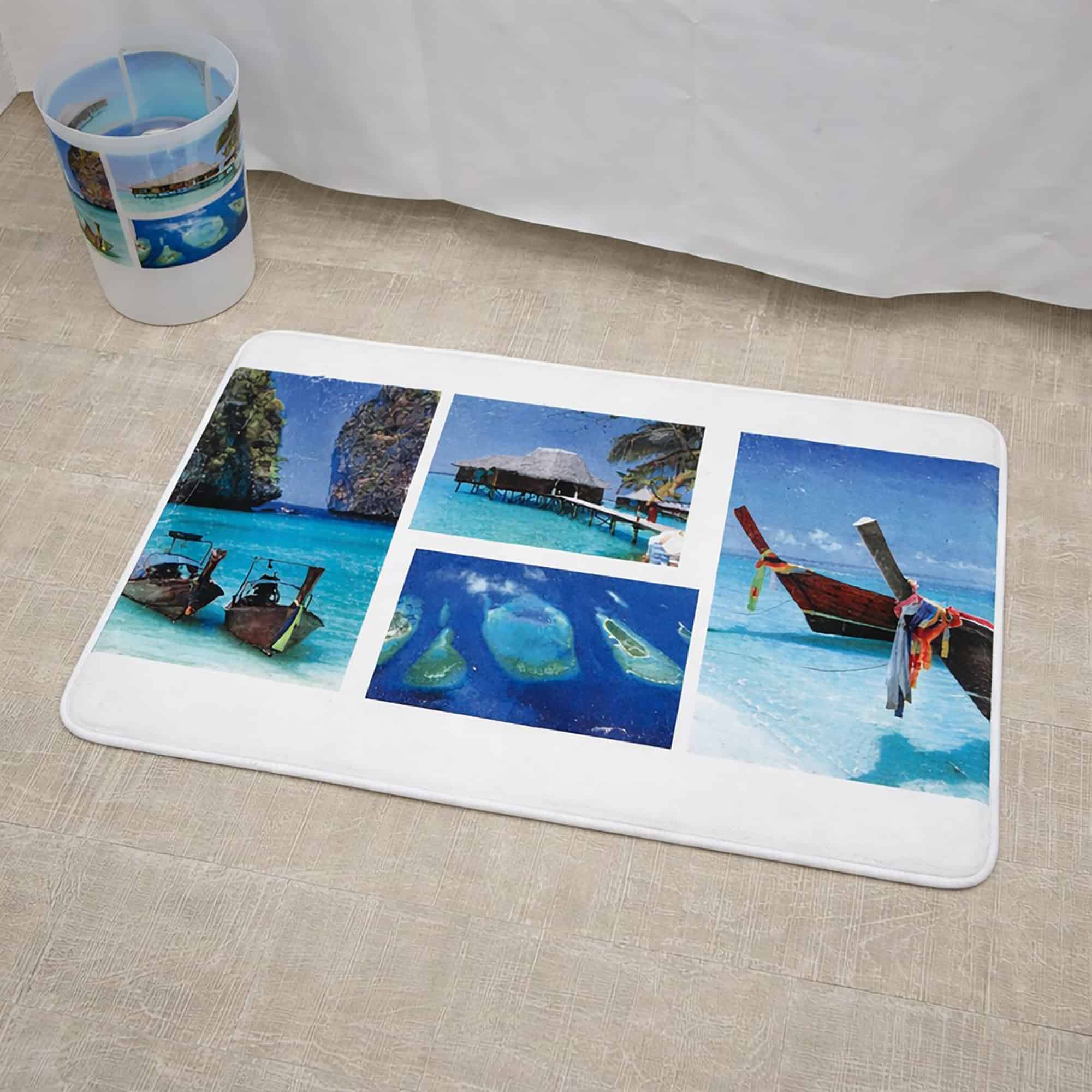 Close-up of paradise print bath mat on wood-look floor beside bathtub with matching wastebasket