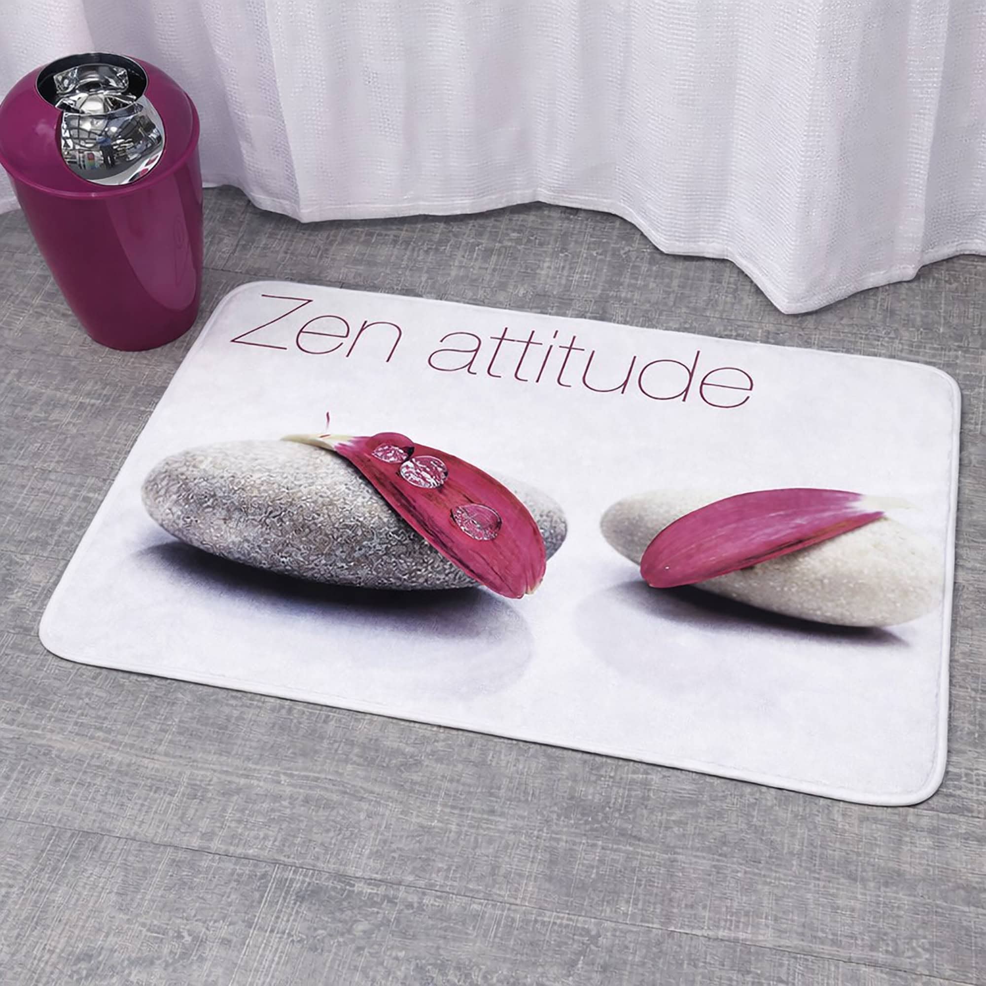 "'Zen attitude' bath mat with spa stone and pink petal print next to shower curtain and pink accessories"