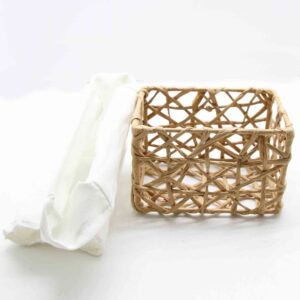 Natural beige paper rope basket shown empty beside its removed white linen liner on a white background.