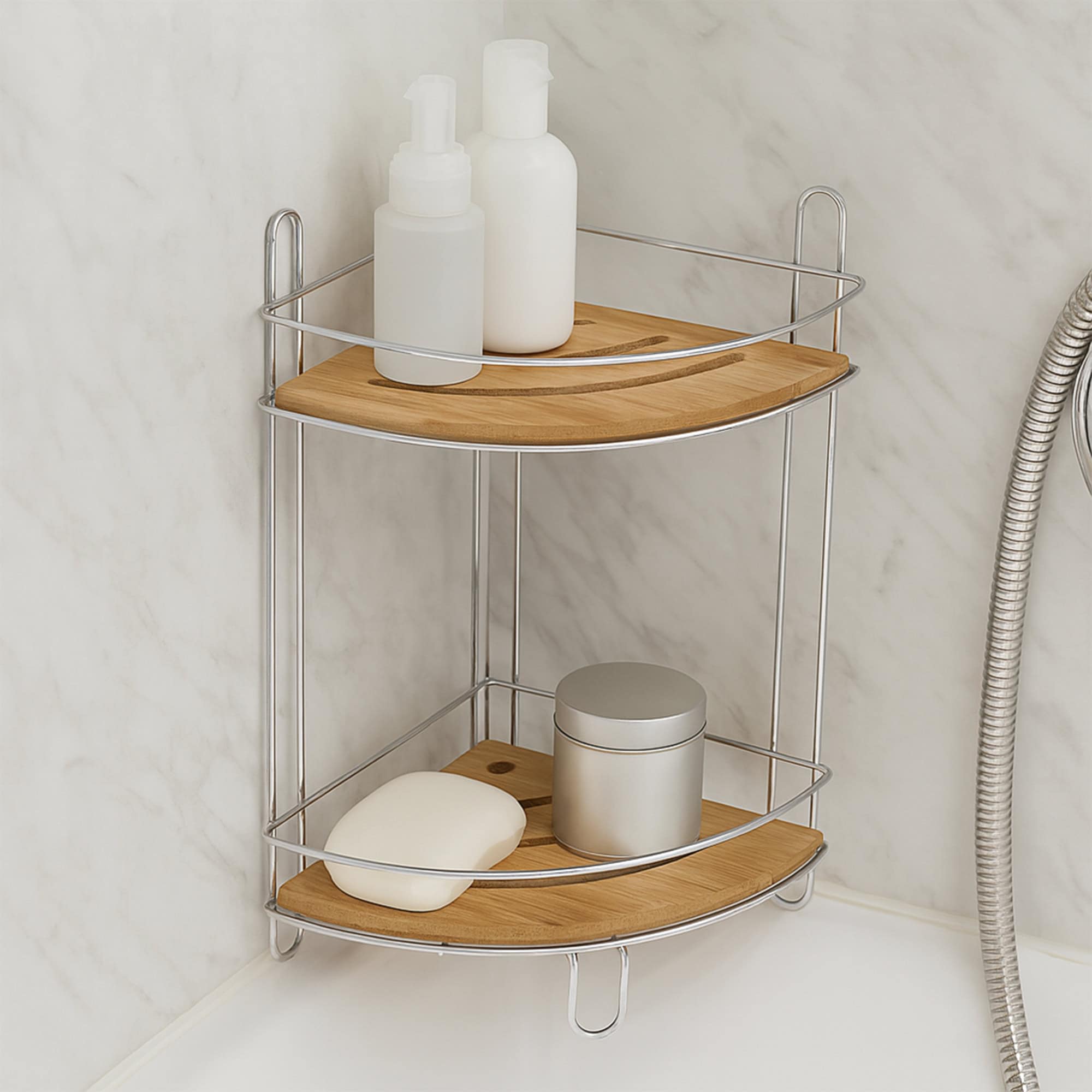 Image 3: Chrome 2-shelf corner storage tower with bamboo shelves holding shampoo bottles, soap, and a canister against a marble-effect bathroom wall.