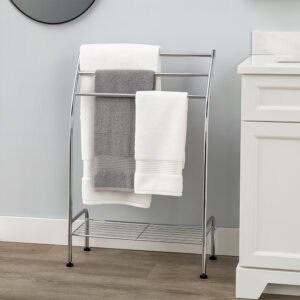 "Chrome curved 3-bar towel rack holding gray and white towels in bathroom with white vanity"