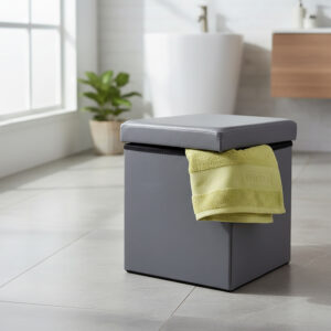 "Gray faux leather folding storage ottoman with open lid holding yellow towel in modern bathroom"