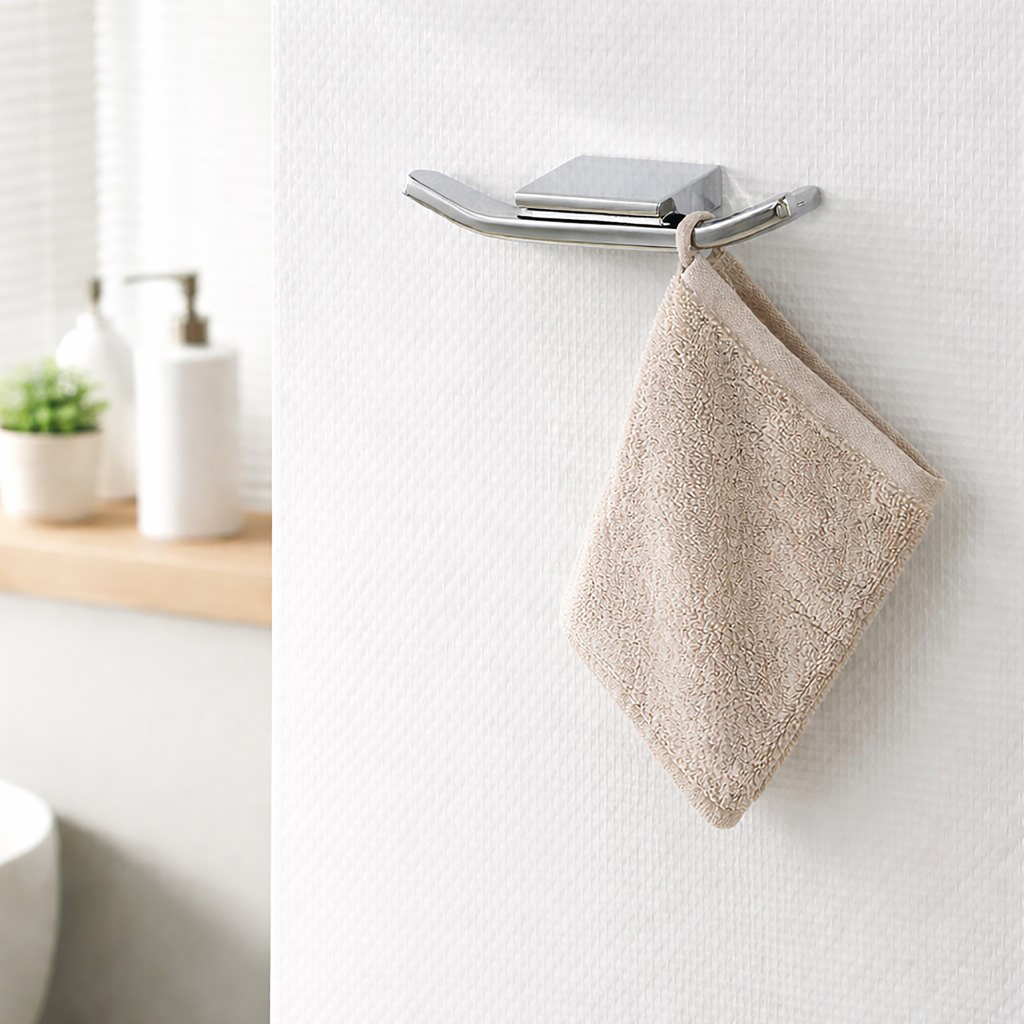 "Chrome double wall hook with washcloth hanging in modern bathroom"