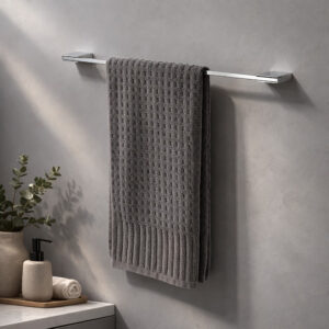"Chrome 24-inch towel bar with gray waffle towel mounted on gray wall in styled bathroom"
