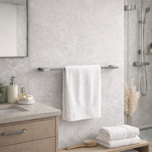 "Chrome towel bar with white towel on marble-look wall beside walk-in shower"