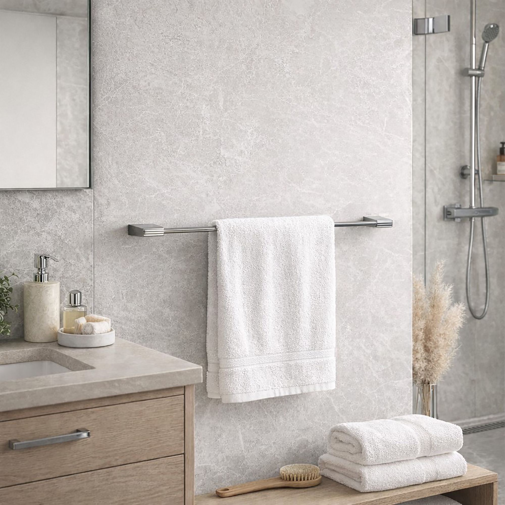 "Chrome towel bar with white towel on marble-look wall beside walk-in shower"