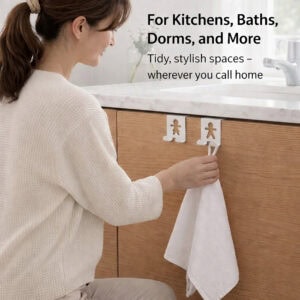 "Woman hanging white towel on figure-shaped cabinet hooks on wood bathroom vanity"